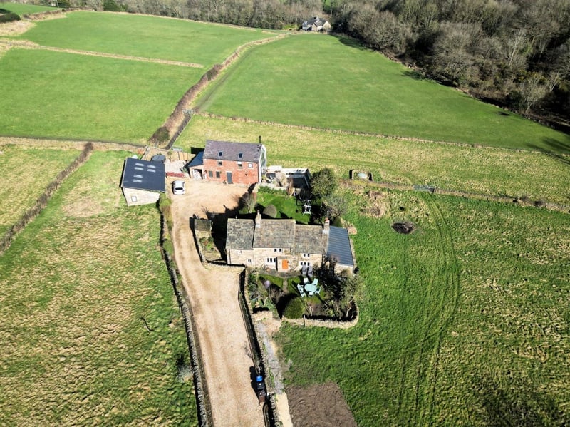 Outbuilding conversions have given this plot three dwellings.