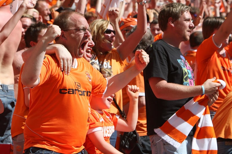 Let the good times roll! Blackpool fans celebrate the 3-2 win against Cardiff in the 2010 Championship play-off final