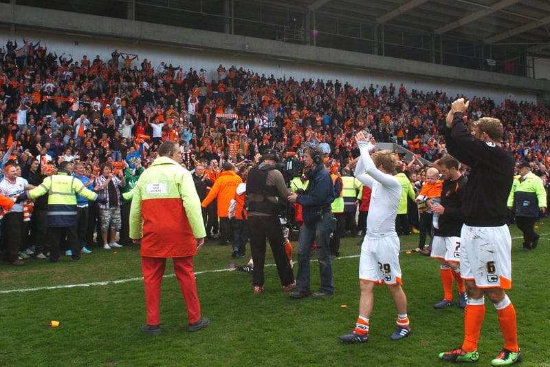 The Bloomfield Road faithful celebrate at the final whistle after their side's 1-1 draw with Bristol City was enough to earn the Seasiders a 2009-10 play-off spot