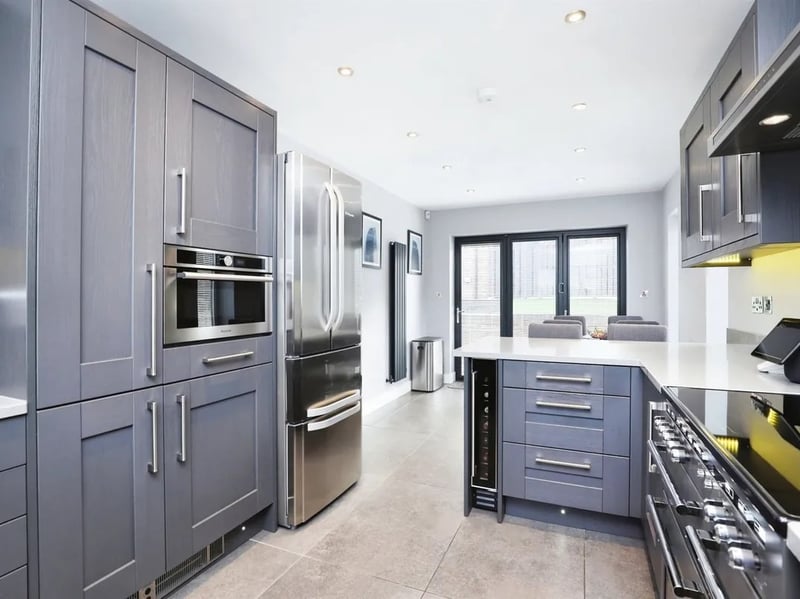 The kitchen has a lovely, modern finish and shares this space with a dining area.