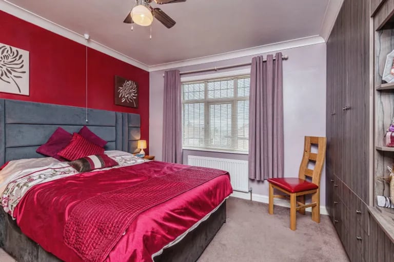 The second bedroom adds and extra splash of colour and also features built-in storage.