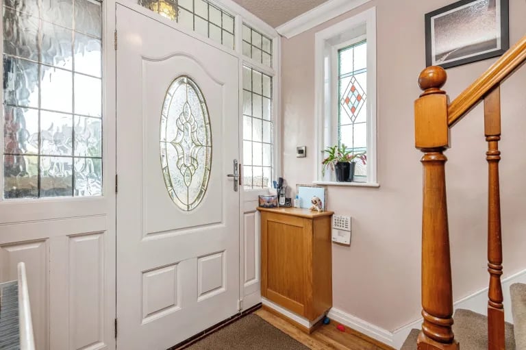 Enter via the entry porch and this beautiful door into a hallway with stairs to the first floor and access to ground floor rooms.