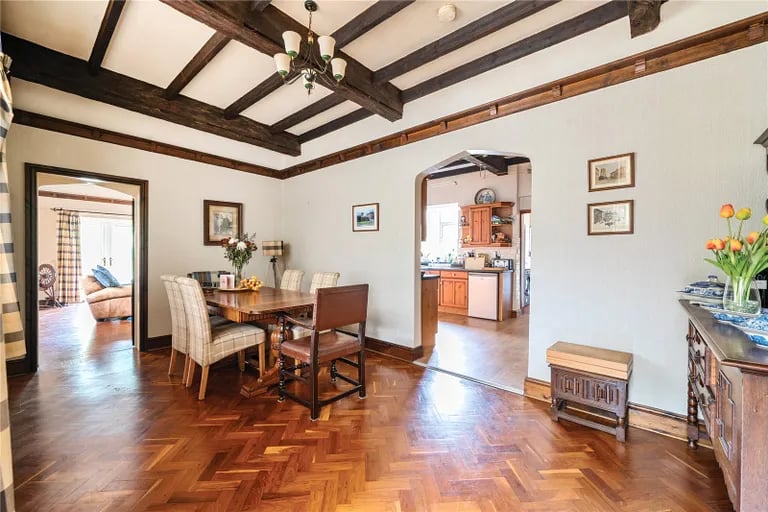 This spacious room with exposed wooden ceiling beams is a great place to entertain.