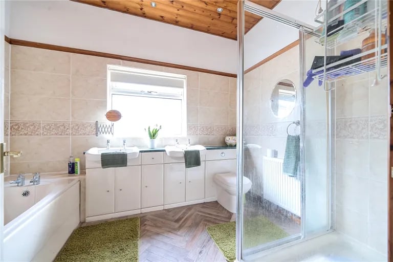 Along with this en-suite there is a family bathroom and further shower room.