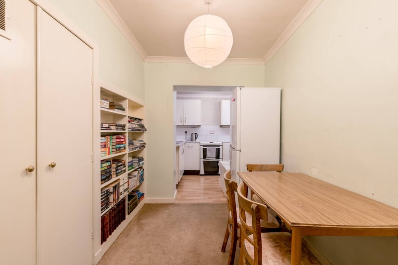 Between the kitchen and lounge is a breakfast room, fitted with cupboards and shelving. The fitted kitchen has wall and base mounted cabinetry, worktops and an electric cooker.