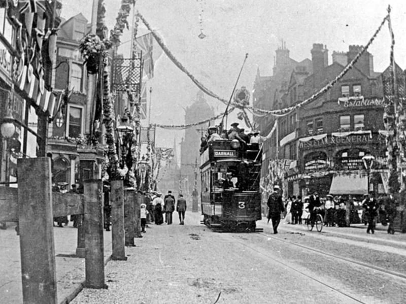 A double-decker tram on Pinstone Street, Sheffield, decorated for the visit of King Edward VII in 1905