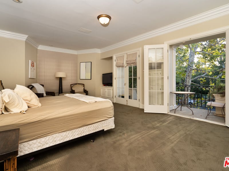 One of the many bedrooms in the mansion, however this one has the bonus of a verander only a few steps away from the bed (Credit: The MLS)