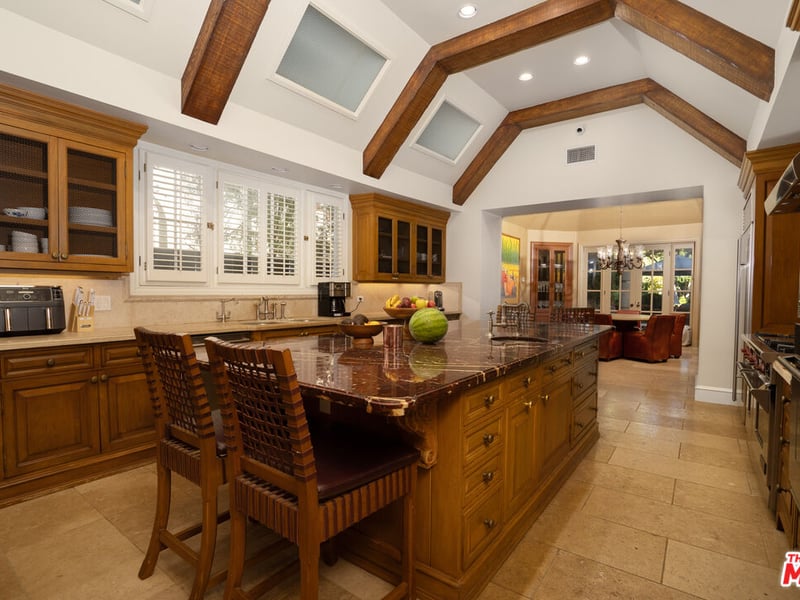The kitchen, complete with breakfast bar, walks through into a smaller, bespoke dining area for breakfasts (Credit: The MLS)