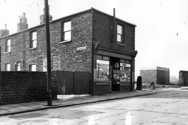 Prospect Grove is on the left of this view with number 112 Ley Lane on the end of the row in March 1964. This is a grocers shop. The entrance to a large recreation ground can be seen on the right. Property included in slum clearance plans for the Armley Road area. A public toilet can be seen to the right.