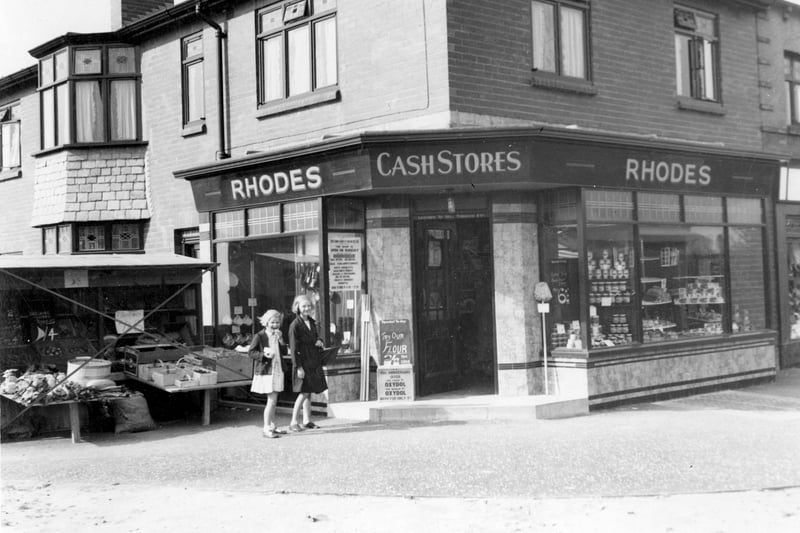 Rhodes, grocery store is on the corner of Vesper Road with Woodhall Drive in September 1937. A stall selling fresh produce has been set up on the pavement. The City Engineer has marked this on the photograph with a red cross implying that permission has not been granted.