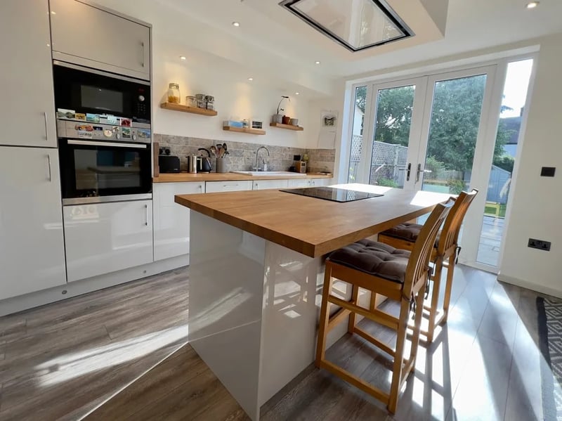 The kitchen looks very modern. The kitchen island is a popular, contemporary feature.