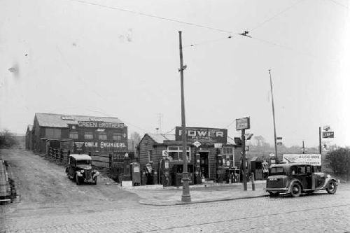 Green Brothers motor engineers on Commercial Road. Shows petrol kiosk with pumps to front and workshops accessible via mud track. Pictured in April 1937.