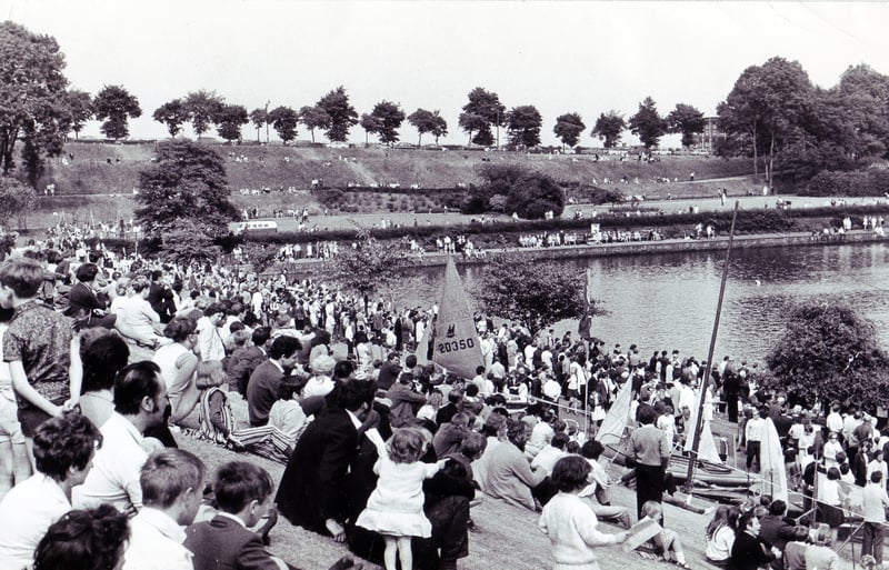 Hundreds of people line the grassy banks at Crookes Valley Park to watch the Water Sports Gala in June 1970