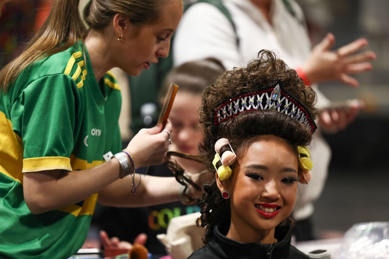 An Irish dancer getting her hair prepared ahead of the opening night at the World Irish Dancing Championships Glasgow