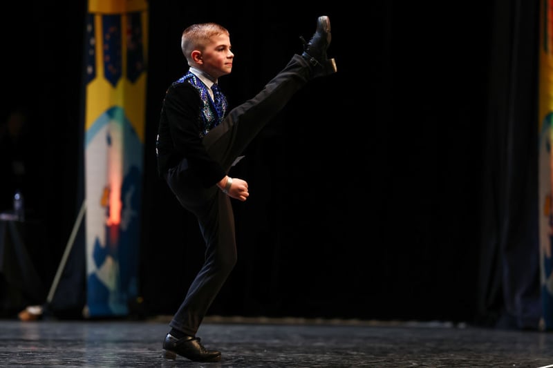 An irish dancer shows off with a high kick at the World Irish Dancing Championships Glasgow