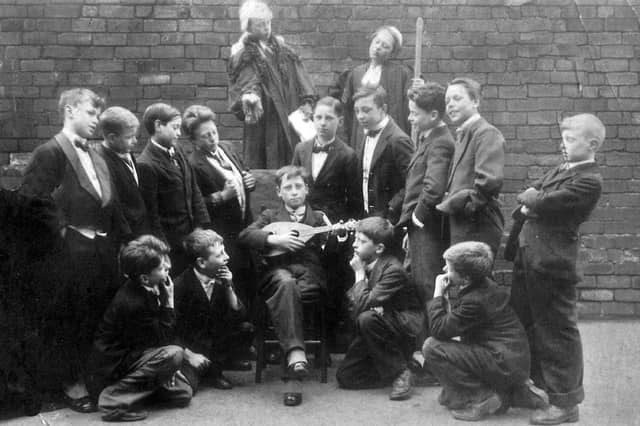 Pupils of St. Luke's School taking part in a production of Gilbert and Sullivan's comic opera Trial by Jury in April 1926. Standing fourth from the right is Jim Wheeler but no other names are known.