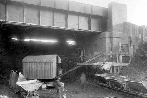 A view of a newly built bridge on Beeston Ring Road. A mechanical shovel is filling trucks with debris from the site. Pictured in December 1928.