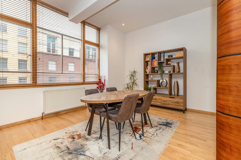 The fabulous living dining space spans 30 ft (at widest points) with real wood flooring and a feature wall of almost full height windows facing over Wilson Street.