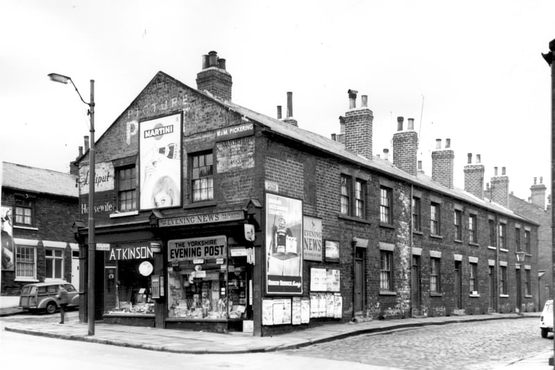 The two shops fronting onto Armley Road are Atkinsons at 176 and a newsagents at number 174, business of W. & M. Pickering. The faded sign on the wall gives the name of the previous proprietor, Arthur H. Moorhouse listed in the 1955 Barrett City of Leeds Directory. A Morris traveller is parked on Halifax Place, far left. Pictured in February 1964.