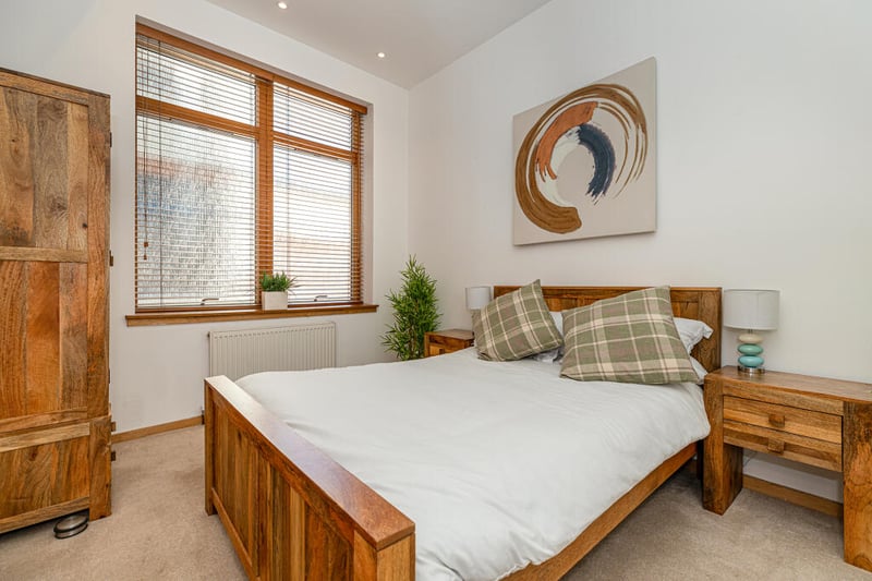 Bedroom two is a spacious double room with carpeted floorcoverings, two integrated double wardrobes and two large windows facing away from the street.