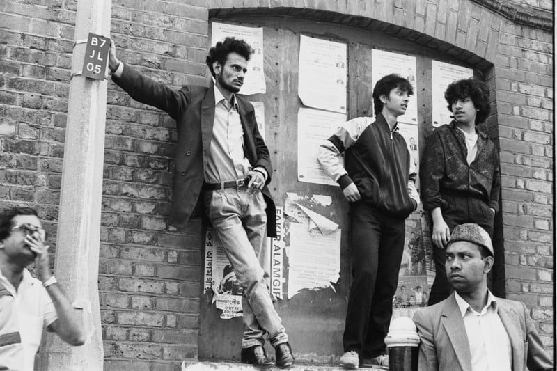 Men await a visit by Prince Charles to Brick Lane in 1987. 