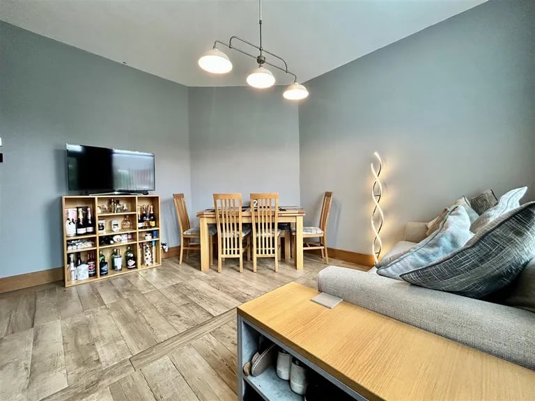 To the rear is a second sitting room combined with dining room.