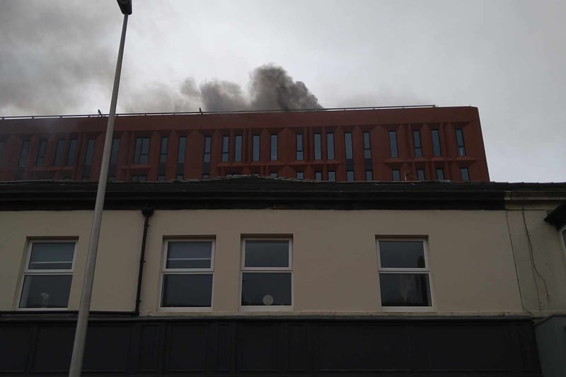 Fire crews have used foam to tackle the fire on the top of the building