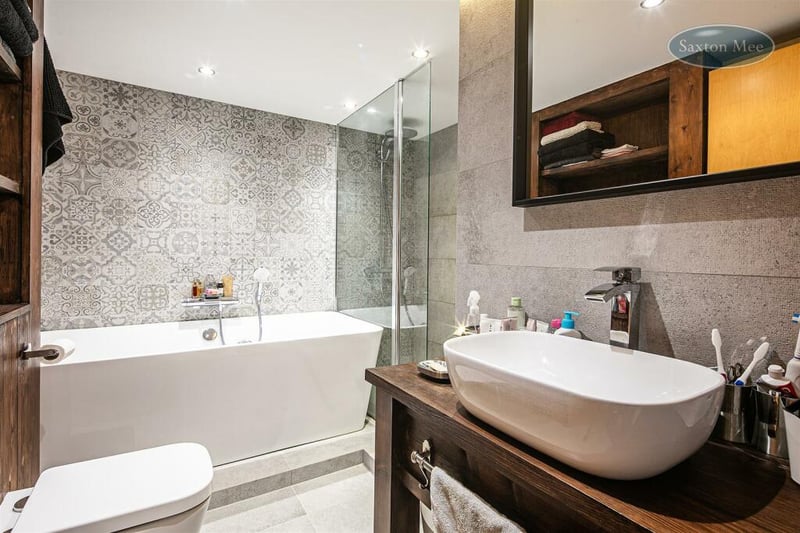 The bathroom has a modern and sophisticated design.