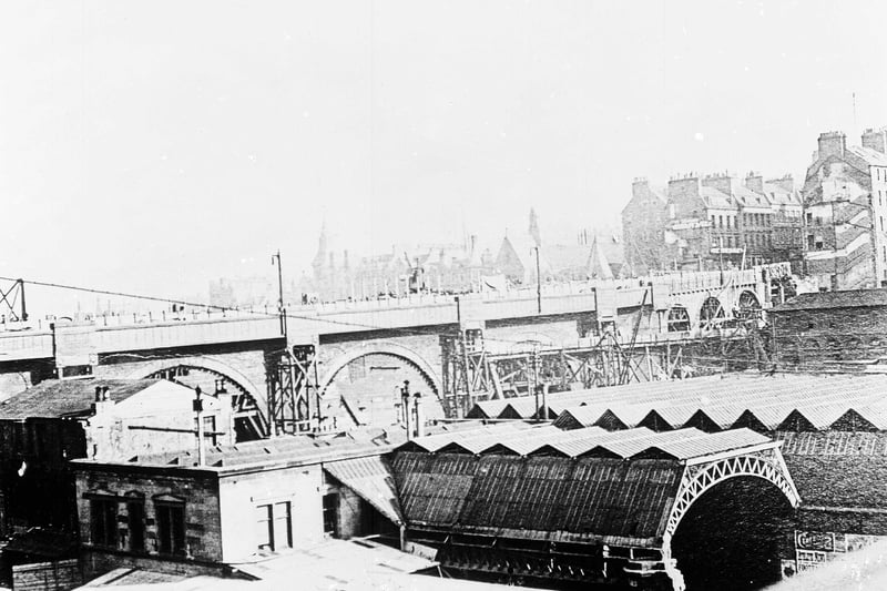 An archive photo of the construction of North Bridge, which opened in 1897. The roof of Waverley Station is seen in the foreground.
