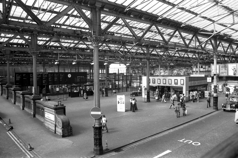 Interior of Waverley station in Edinburgh, August 1976, showing the old destination board and John Menzies shop.