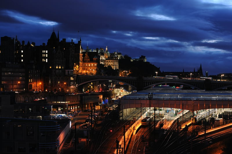 Views of Edinburgh city centre at dusk.  View from Regent Road looking south west over Waverley Station to the Old Town, The Mound and Edinburgh Castle.  