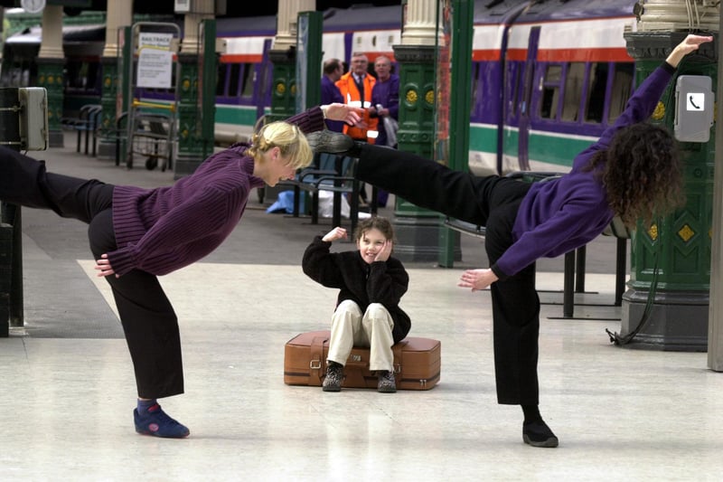 Tabula Rasa Dance Company dancers Clare Hughs and Claire Pencak dancing on the main platform at Waverley Station in July 2012, watched by 8-year-old Alix Tulloch from Musselburgh who was waiting for a train to go on holiday to Bristol.