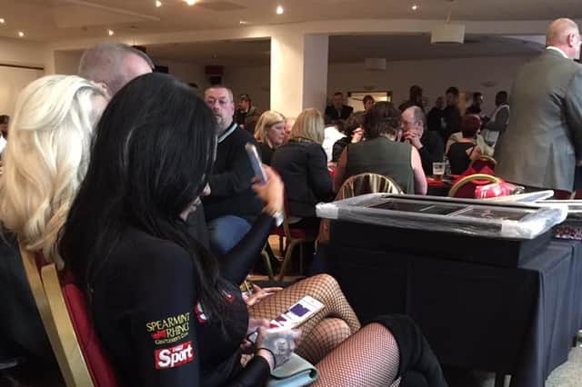 A ring card girl takes a break at a Sheffield show
