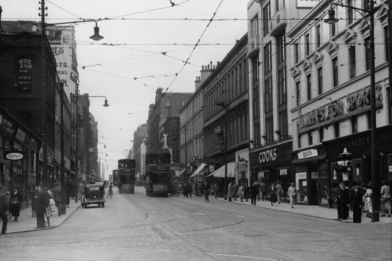 Sauchiehall Street, one of Glasgow's busiest shopping streets with trams passing down the street in 1937. 