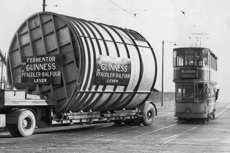 A tram flanks a 10-ton stainless steel fermenting tun on the outskirts of Glasgow on its way to the docks to be shipped to the Guinness Brewery in Dublin, March 14 1949. Made at the Pfaudler-Balfour construction works in Leven, Glasgow, the tun can hold 150,000 pints of Guinness.