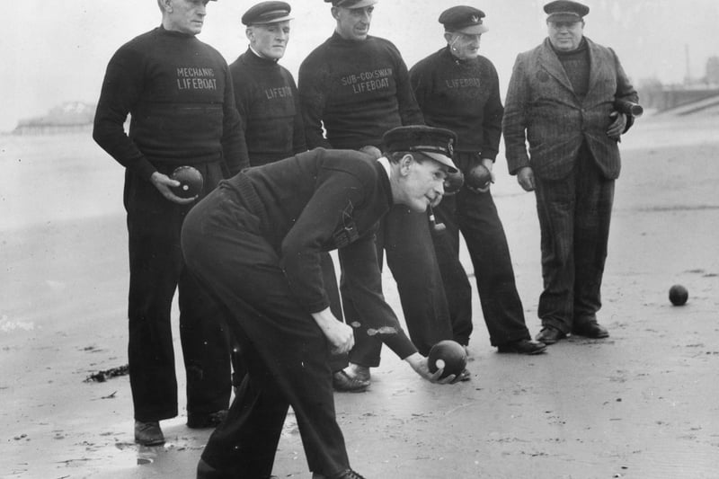 30th November 1939:  The crew of the Blackpool lifeboat relaxing with a game of bowls on the beach