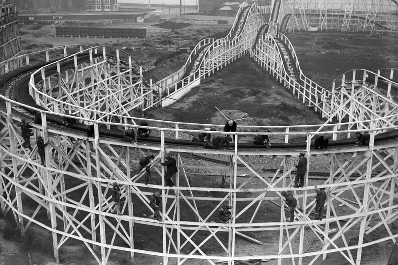 26th March 1934:  Men at work on the big dipper at a Blackpool amusement park