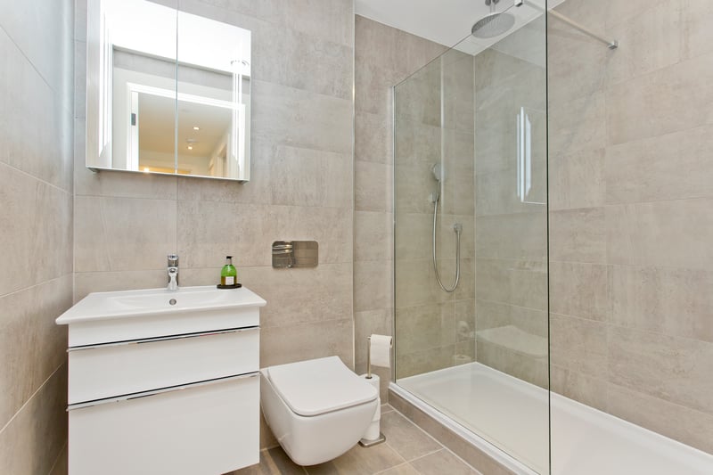 The family shower room has a double rainfall shower and an illuminated mirror.