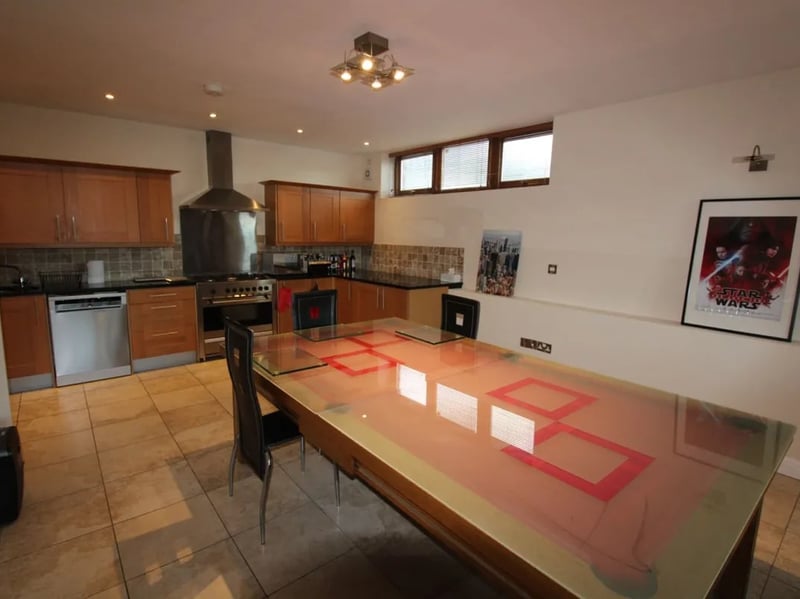 The space consists of a sitting area, dining space and kitchen.