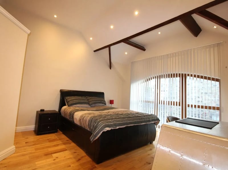 The first floor bedrooms benefit from very high ceilings. This master bedroom is fitted with an en-suite.