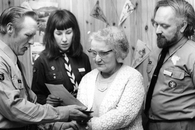 George Simpson, deputy group Scout leader, presents a replica of the group's neckerchief to Mrs Mary Cleveland in recognition of her 25 years' service to the South Shields 22nd Scout Group in 1971