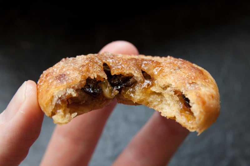 An Eccles cake is a small, round pie, similar to a turnover, filled with currants and made from flaky pastry with butter, sometimes topped with demerara sugar.