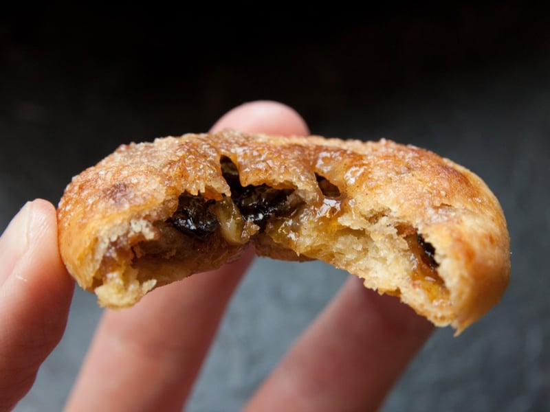 An Eccles cake is a small, round pie, similar to a turnover, filled with currants and made from flaky pastry with butter, sometimes topped with demerara sugar.