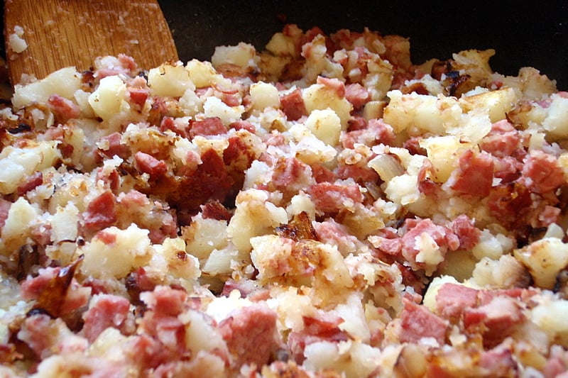 A traditional store cupboard supper of fried potatoes with thrifty corned beef.