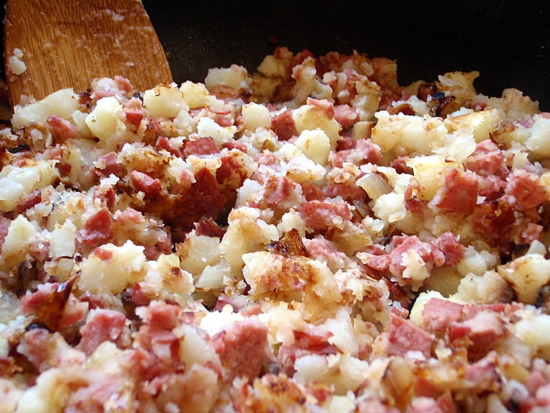 A traditional store cupboard supper of fried potatoes with thrifty corned beef.