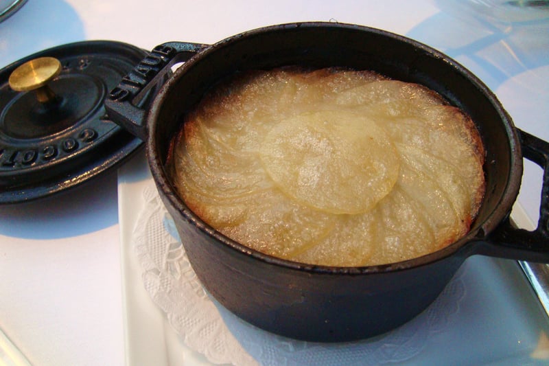 Lancashire hotpot is a stew originating in Lancashire in the North West of England. It consists of lamb or mutton and onion, topped with sliced potatoes and slowly baked in a pot at a low heat.