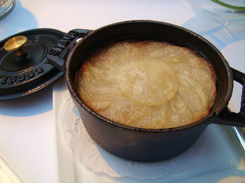 Lancashire hotpot is a stew originating in Lancashire in the North West of England. It consists of lamb or mutton and onion, topped with sliced potatoes and slowly baked in a pot at a low heat.