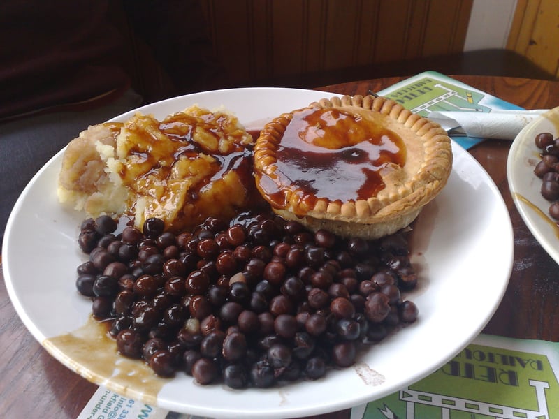 Black peas, also called parched peas or dapple peas, are cooked purple-podded peas. They are a traditional Lancashire dish usually served with lashings of malt vinegar.