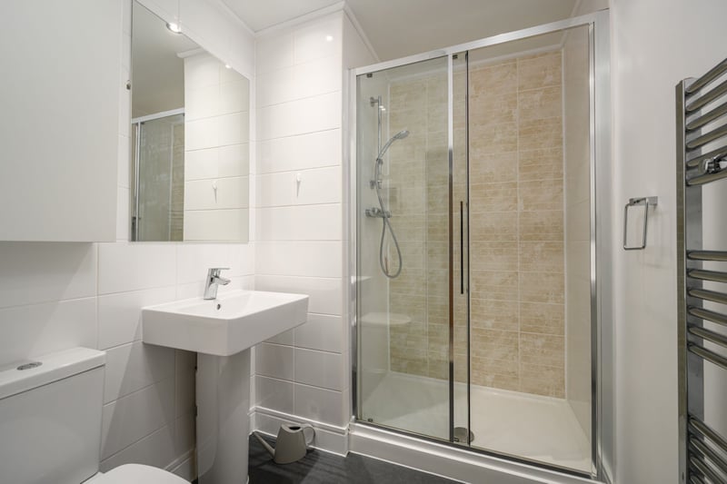 The principal bedroom's en-suite shower room with modern white suite.