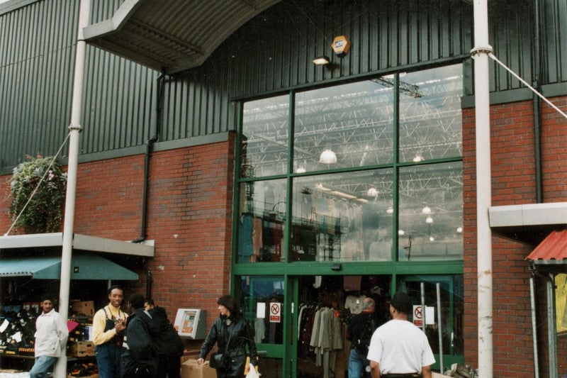 The entrance of the newly refurbished front of Kirkgate Market. Stalls selling shoes to left and right. Pictured in September 1999.